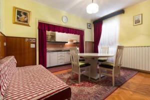a living room with a table and chairs and a kitchen at Primošten-Huljev in Primošten