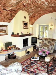 a living room with a fireplace and a couch at 2 bedrooms apartement with enclosed garden at Carru in Carrù