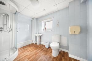 a bathroom with a toilet and a sink at Riverside Mews in Brigg
