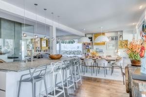 a kitchen and dining room with a large island with bar stools at Chalet Ardoise in Praz-sur-Arly