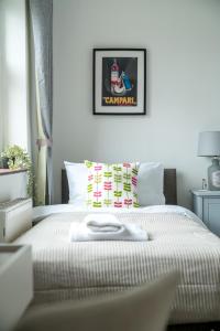 a white bed with a white towel on it at Stunning flat In London on Central Line - sleeps 5 in Woodford Green