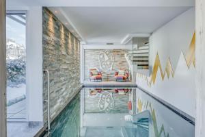 a house with a swimming pool and a glass floor at Chalet Ardoise in Praz-sur-Arly