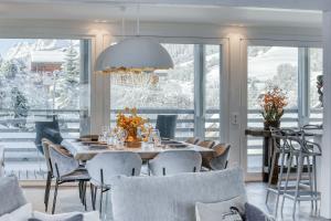 a dining room with a table and chairs at Chalet Farniente in Praz-sur-Arly +33 photos