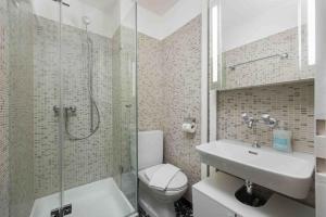 a bathroom with a toilet and a shower and a sink at Cozy Urban Studio in the City BE-41 in Zürich