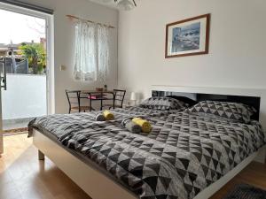 a bedroom with a bed with two pillows on it at Rooms MARE in Poreč