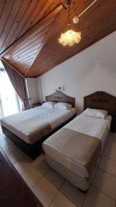Postel nebo postele na pokoji v ubytování Kutberk Hotel Kemer