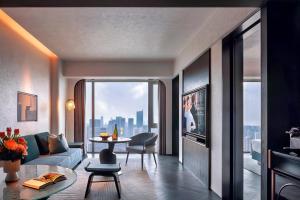 a living room with a couch and a table at Sofitel Shanghai North Bund in Shanghai