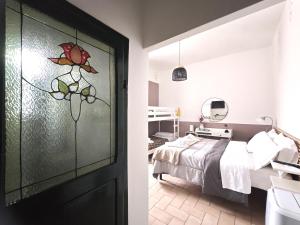 a bedroom with a bed and a glass door at La Casa dei Carrai in Pitigliano