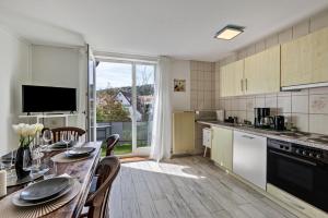a kitchen with a table with chairs and a dining room at Apartment Alb Glück 1 in Hechingen