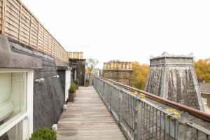 a balcony with a wooden walkway next to a building at Numa London Bloomsbury in London