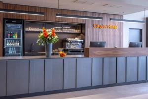 a bar with a vase of flowers on a counter at City inn Olomouc in Olomouc