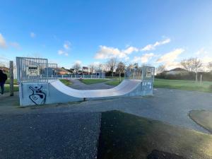 a skate park with a skateboard ramp in a park at Majestic 2 bedroom House Milton Keynes in Milton Keynes