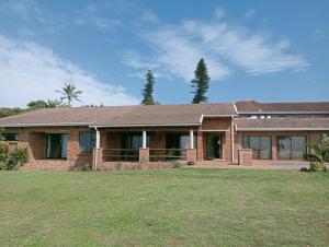 a brick house with a yard in front of it at Ocean Vista in Amanzimtoti