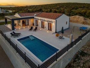an aerial view of a house with a swimming pool at Villa Cesarica ZadarVillas in Kakma