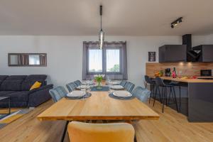 a dining room and living room with a table and chairs at Villa Cesarica ZadarVillas in Kakma