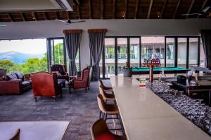 a living room with a pool table and chairs at La Joya Lodge Conference Centre and Spa in Pelindaba