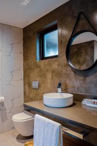 a bathroom with a sink and a mirror at La Joya Lodge Conference Centre and Spa in Pelindaba