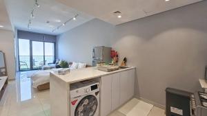 a kitchen with a washing machine in a room at Executive studio in Dubai