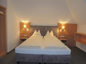 a bedroom with a large white bed with two lights at Haus Christophorus in Obergurgl