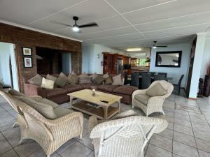 a living room with a couch and chairs and a table at Ocean Vista in Amanzimtoti