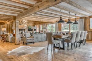 a kitchen and dining room with a table and chairs at Chalet Charvin in Megève