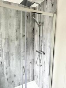 a shower with a glass door in a bathroom at New Stunning 5 Bedroom House-Wi-Fi-Parking-Slps 12 in Stroud