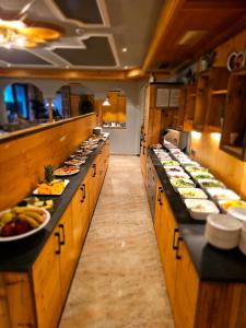 a kitchen with many plates of food on the counters at Hotel Tonnerhof in Racines