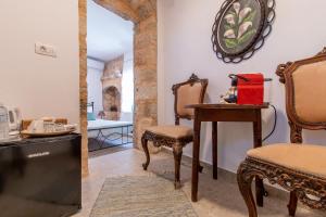 a room with a chair and a table and a mirror at Casa Ifestou in Rhodes Town