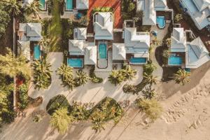 an aerial view of a resort on the beach at Devasom Khao Lak Beach Resort & Villas in Khao Lak