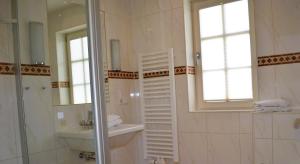 a white bathroom with a sink and a mirror at Insel Landhaus Seaside in Gager +55 photos