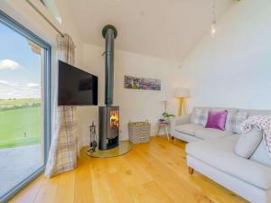 a living room with a white couch and a fireplace at 2 Bed in Montgomery 83243 in Llandyssil