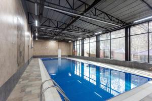 a large swimming pool with blue water in a building at Maajid Quba Hotel&Restaurant Sanatorium in Quba
