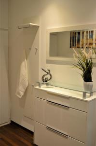 a white bathroom with a sink and a mirror at Charmante Zimmer Wohnung Stilvoll in Münster