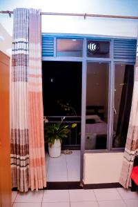 an open window with curtains in a room at Iwawe by IBC- Entire house in Kigali