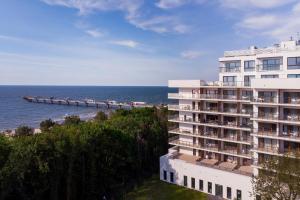 a hotel overlooking the ocean and a pier at Aquamarina Prima Deluxe Studios With Sea View by Renters in Międzyzdroje