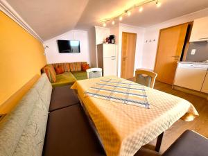 a living room with a couch and a table in it at Pension Alpina Neustift in Neustift im Stubaital