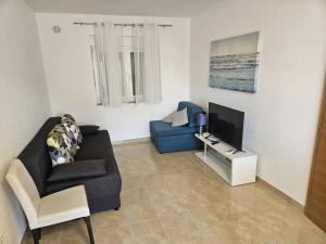 a living room with a couch and a tv at Apartmani Paula in Vodice