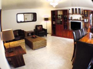 a living room with a couch and a table at Casa Ladera in Las Lagunas Mijas