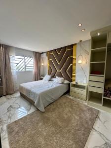 a bedroom with a large bed and a large rug at Mandri apart in Tetouan