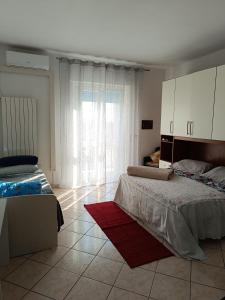 Posteľ alebo postele v izbe v ubytovaní L'appartamento delle vacanze