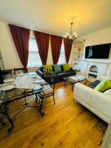 3 bed West Norwood Apartment في West Dulwich: غرفة معيشة مع كنبتين ومدفأة