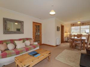 a living room with a couch and a table at Tigh na Drochit in Glenelg