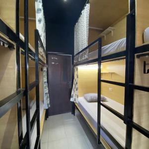 a dorm room with bunk beds in it at Innbox Hostel in Sorong