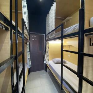 a dorm room with bunk beds in it at Innbox Hostel in Sorong +11 photos