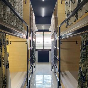 a walk in closet with wooden shelves and a window at Innbox Hostel in Sorong
