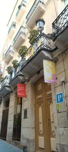 a building with signs on the side of it at Pensión Alicante San Nicolás in Alicante