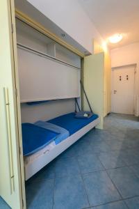 a bedroom with a large bed with blue sheets at Emma's House in Lierna