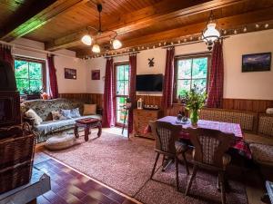 a living room with a table and a couch at Chalupa Žárovička in Velké Losiny