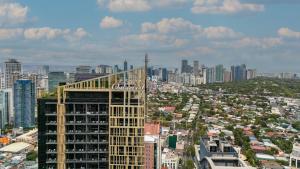 a view of a city with a tall building at Oakwood Makati Avenue in Manila