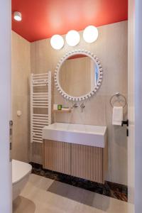 a bathroom with a tub and a sink and a mirror at Agora Suites in Athens